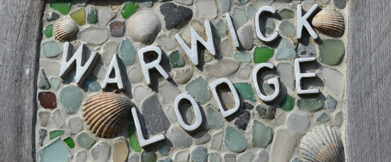 beach-combed warwick lodge sign